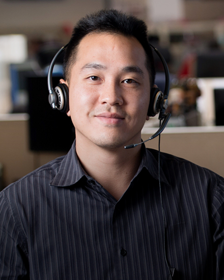 A Con Edison customer service representative wearing a headset.