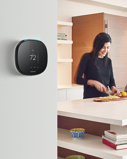 A Smart Thermostat mounted on a kitchen wall