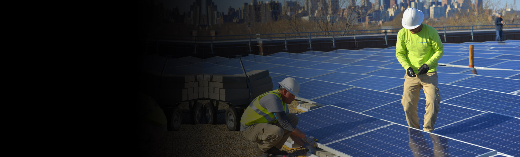 Solar panels are being installed on a rooftop in New York City
