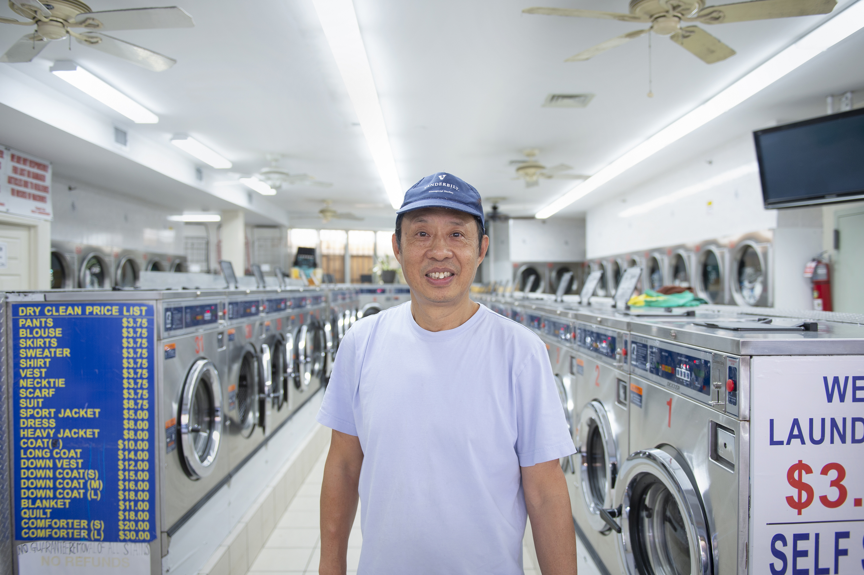 Small business owner poses in laundromat