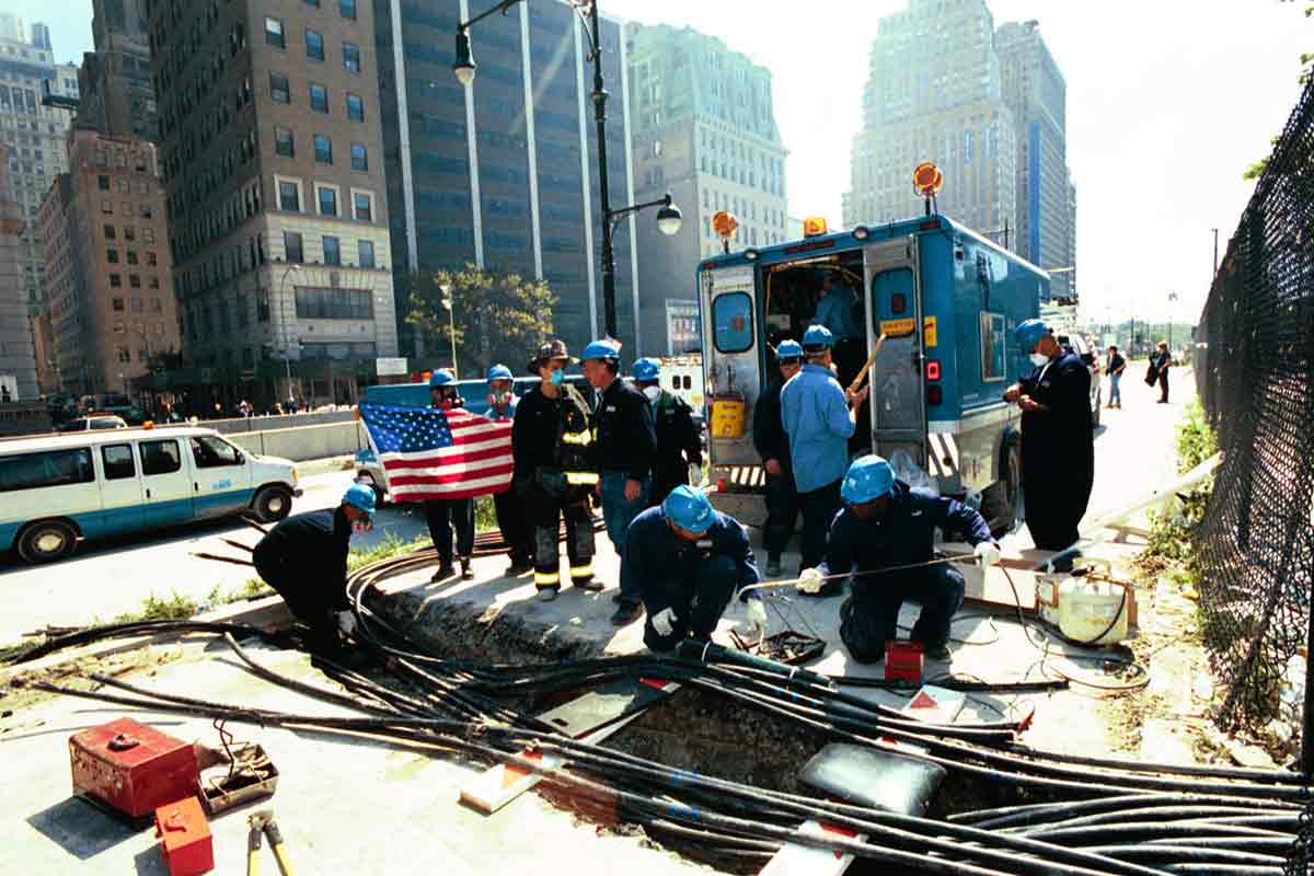 Con Edison employees speak to a firefighter at a worksite near ground zero after nine eleven.