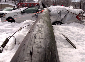 Car demolished by fallen electricity pole