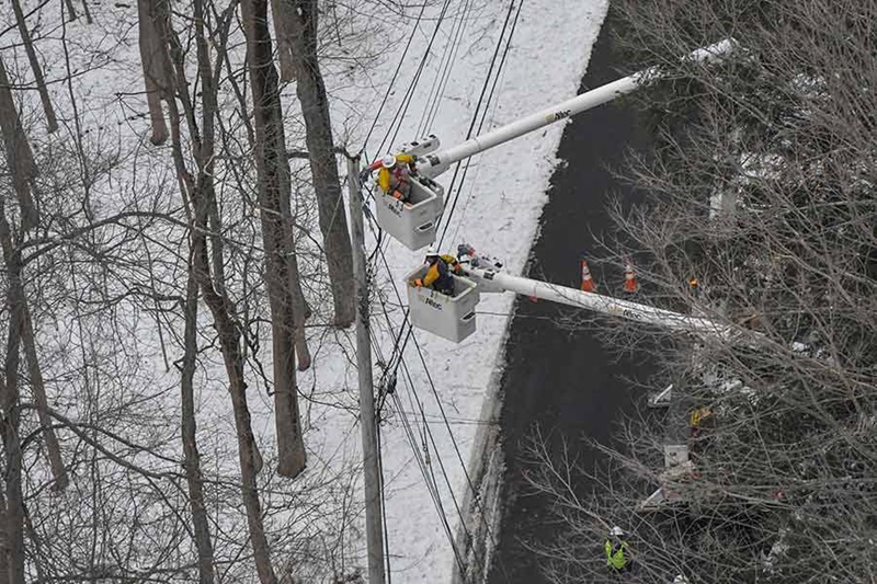 A downed tree and damaged power lines, with a Con Edison truck on the scene. Aftermath of Winter Storm Quinn.