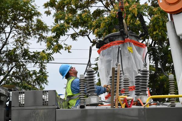 worker removing a transformer