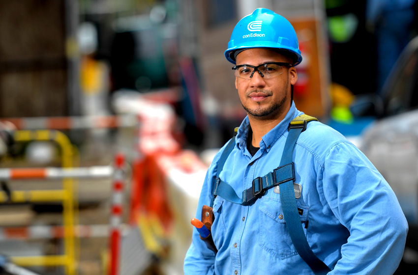 A Con Edison worker wearing a safety harness.