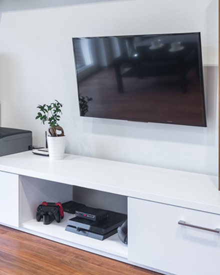 A flat screen TV and other home electronics in a living room.