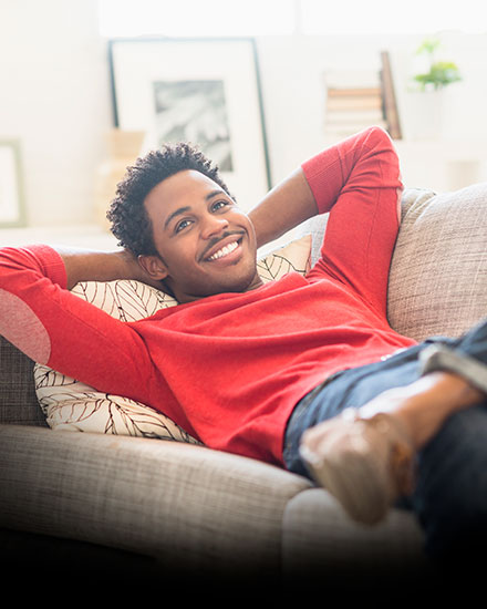 man laying on couch smiling