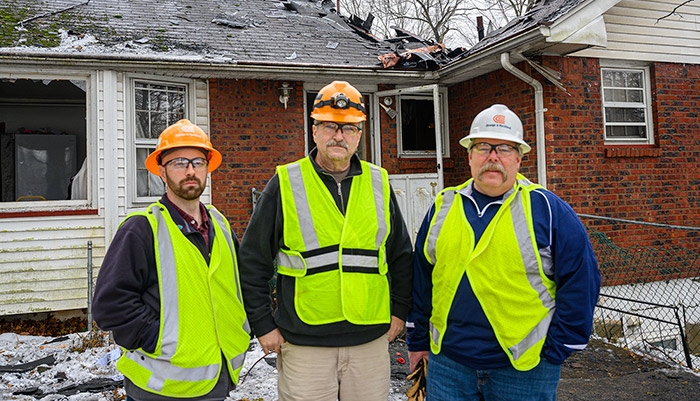 O&R employees James Lynch, Ross Dailey and Ted Ryder on the scene of the December house fire in Monsey where they rescued an elderly man from the burning building.