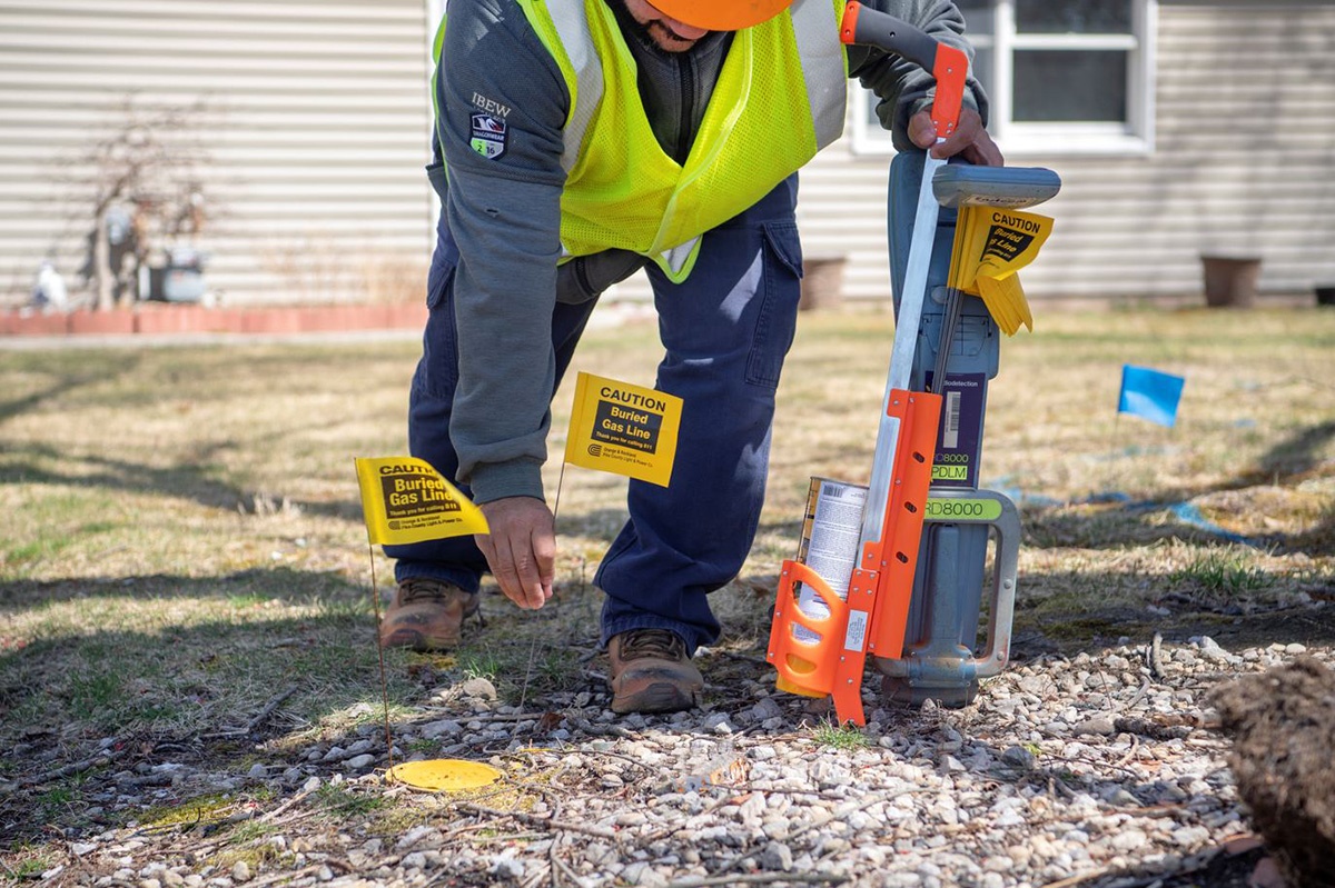 O&R’s Ricardo Dominguez is flagging the location of underground electric and gas utility equipment to prevent excavator damage. 